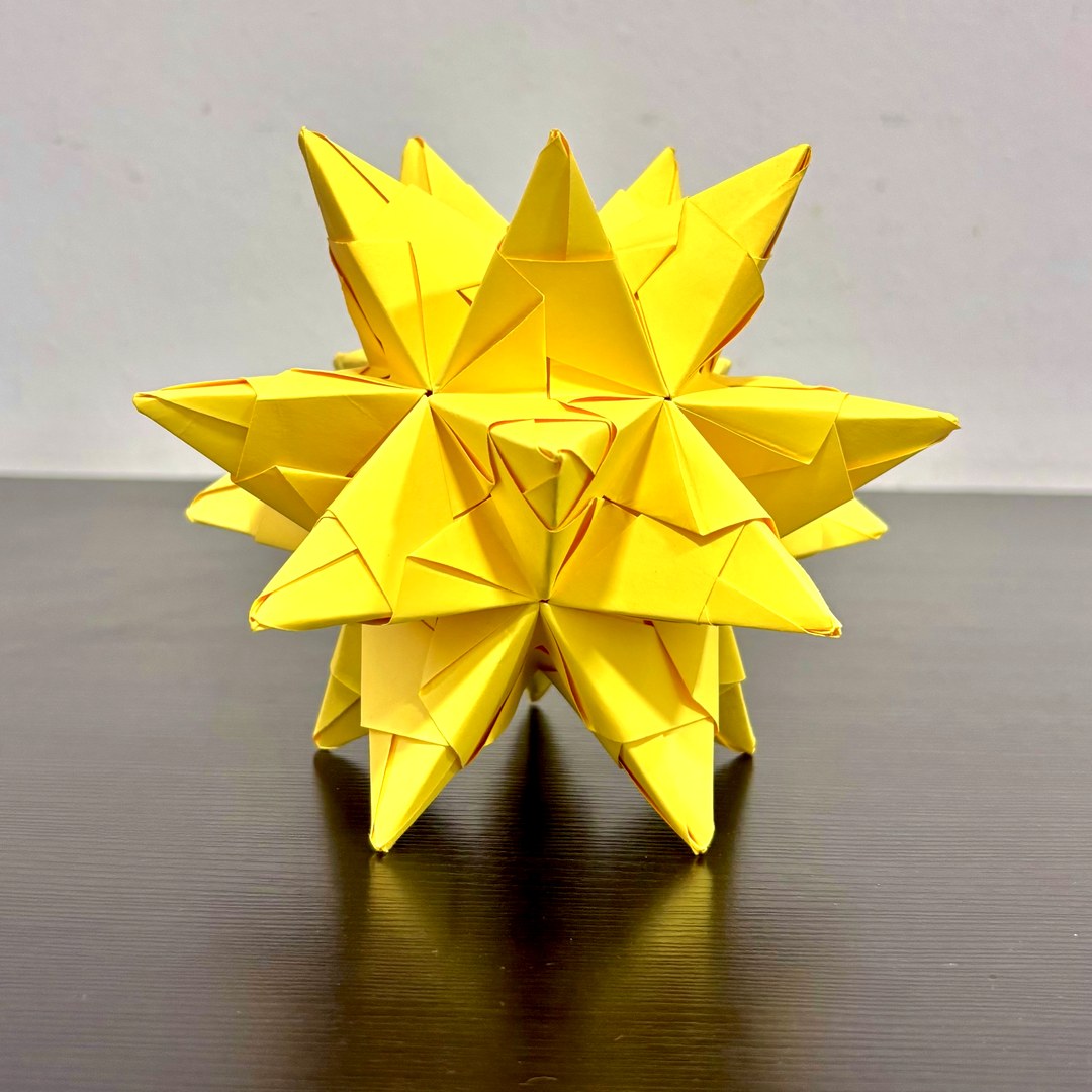 A yellow Bascetta Star, folded by hand from 30 modules